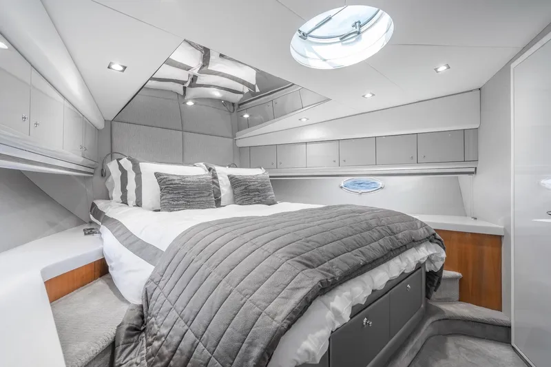 Slide: The Image of Luxurious bedroom interior of 2021 Sunseeker Predator 68 yacht, featuring modern design and elegant decor. - 22