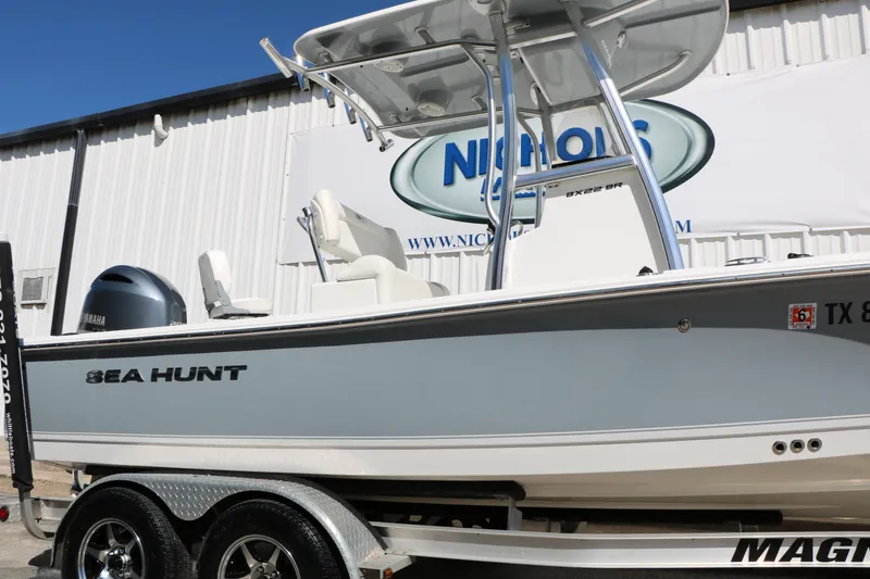 Slide: The Image of 2016 Sea Hunt BX 22 BR boat on trailer, displayed outdoors. - 17