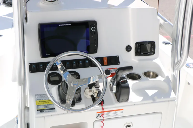 Slide: The Image of 2016 Sea Hunt BX 22 BR boat console with steering wheel and navigation controls. - 26