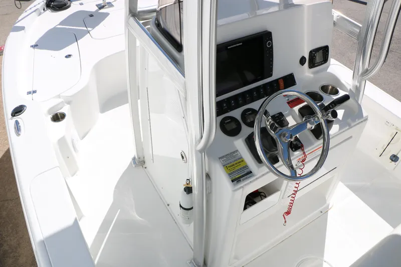 Slide: The Image of 2016 Sea Hunt BX 22 BR boat cockpit with steering wheel and control panel. - 27