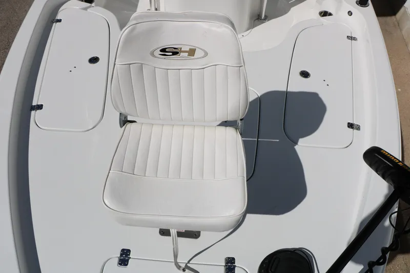Slide: The Image of 2016 Sea Hunt BX 22 BR boat with white seating and storage compartments. - 36