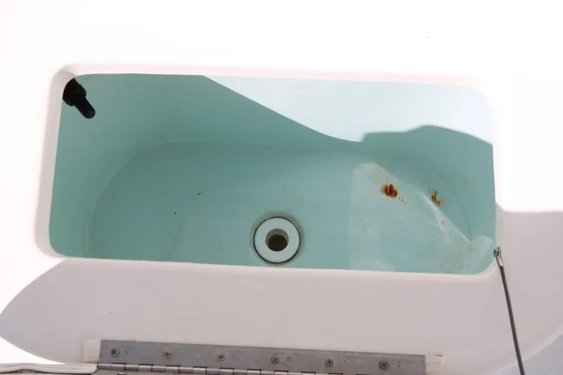 Slide: The Image of Livewell in 2016 Sea Hunt BX 22 BR boat, showing interior and drain. - 38