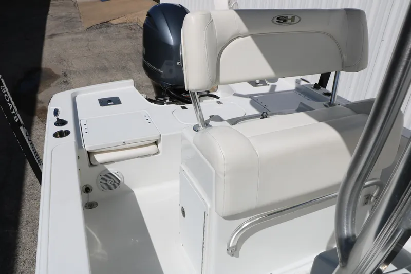 Slide: The Image of 2016 Sea Hunt BX 22 BR boat interior with white seating and motor. - 39