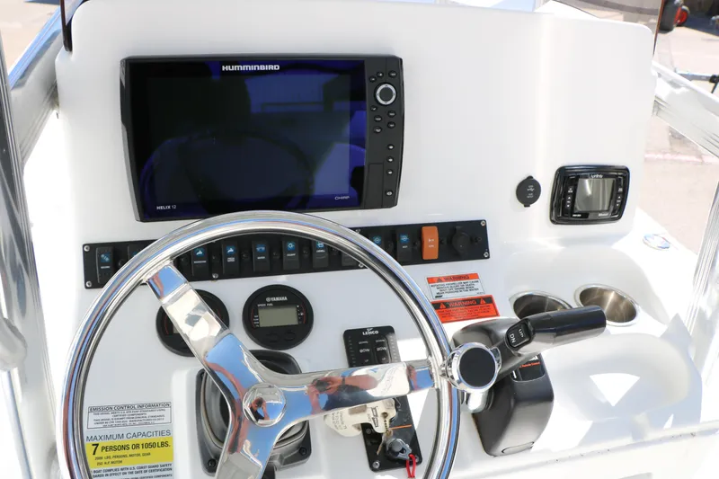 Slide: The Image of 2016 Sea Hunt BX 22 BR boat dashboard with steering wheel and navigation controls. - 47