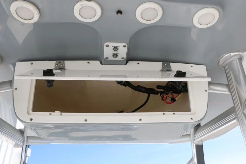 Slide: The Image of 2016 Sea Hunt BX 22 BR boat console with open storage compartment and wiring. - 52