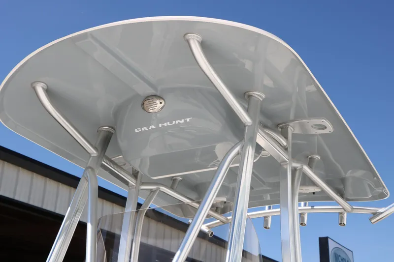 Slide: The Image of 2016 Sea Hunt BX 22 BR boat T-top against clear blue sky. - 8