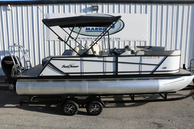 Slide: The Image of 2024 Sun Chaser Geneva SB DH pontoon boat with canopy on trailer. - 12