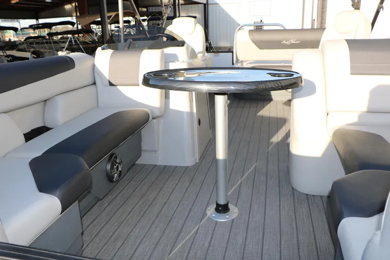Slide: The Image of 2024 Sun Chaser Geneva SB DH boat interior with seating and table in a showroom. - 16