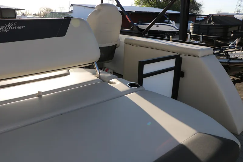 Slide: The Image of 2024 Sun Chaser Geneva SB DH boat interior with beige seating and cup holder. - 23
