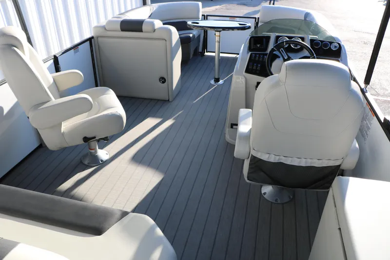 Slide: The Image of 2024 Sun Chaser Geneva SB DH boat interior with plush seating and modern helm. - 25