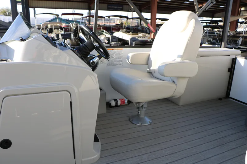 Slide: The Image of 2024 Sun Chaser Geneva SB DH boat helm with captain's chair and steering wheel. - 28