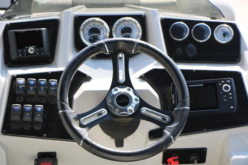 Slide: The Image of Steering console of 2024 SunChaser Geneva SB DH boat with modern controls and gauges. - 32