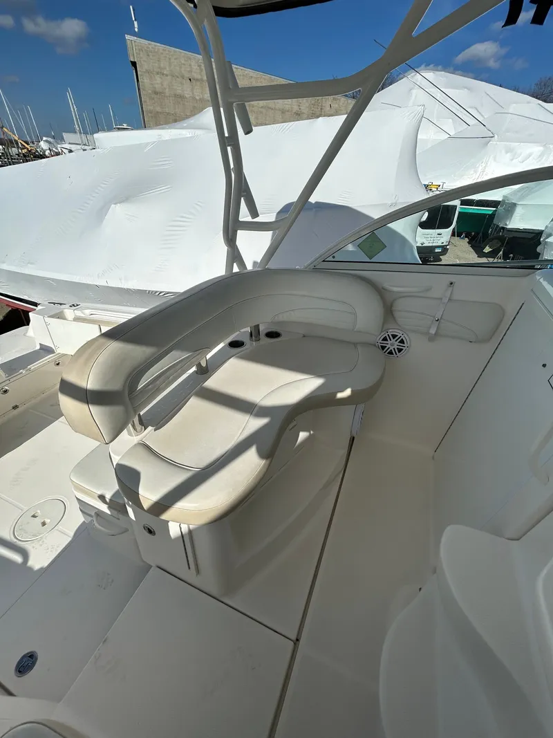 Slide: The Image of Interior of a 2015 Wellcraft 290 Coastal boat with seating area. - 11