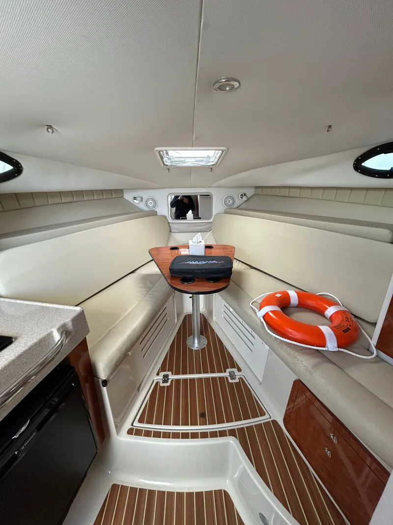 Slide: The Image of Interior of 2015 Wellcraft 290 Coastal with table and life preserver. - 12