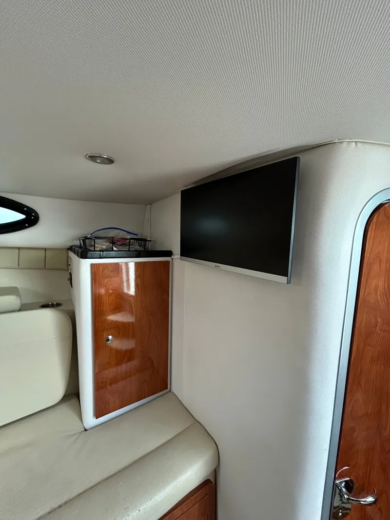 Slide: The Image of Interior of 2015 Wellcraft 290 Coastal with TV and wooden cabinet. - 15