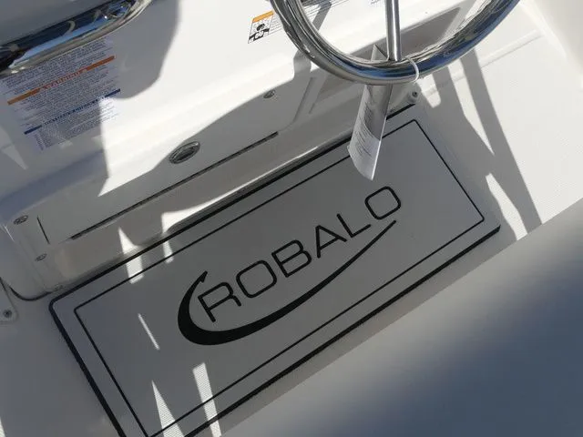 Slide: The Image of Robalo R180 Center Console 2026 helm area with logo. - 16