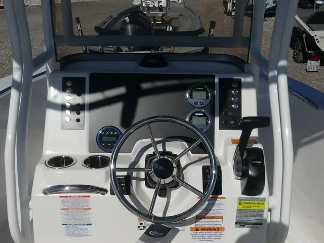 Slide: The Image of 2026 Robalo R180 Center Console dashboard with steering wheel and instruments. - 17