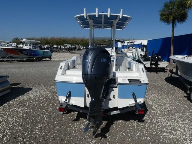 Slide: The Image of 2026 Robalo R180 Center Console with outboard motor on gravel lot. - 5