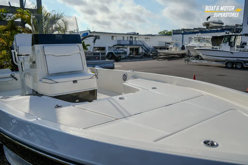 Slide: The Image of 2026 Skeeter SX230 boat displayed at a marina with other vessels. - 10