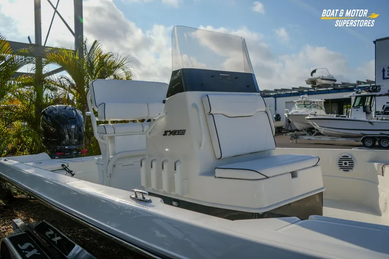 Slide: The Image of 2026 Skeeter SX230 boat with sleek design, white seating, and modern console. - 11