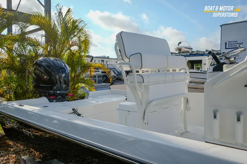 Slide: The Image of 2026 Skeeter SX230 boat with Yamaha engine, white seating, and outdoor showroom setting. - 13