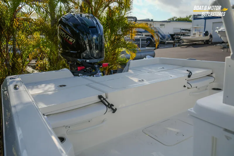Slide: The Image of 2026 Skeeter SX230 boat with powerful outboard motor, showcased at dealership. - 16