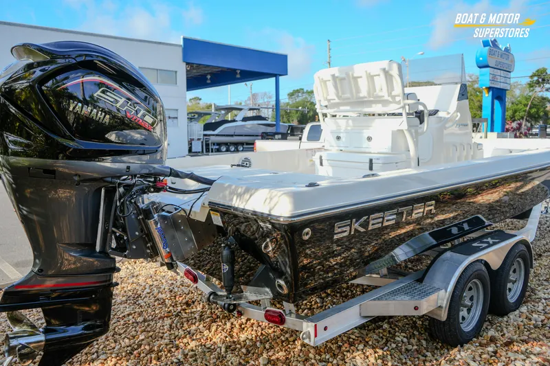 Slide: The Image of 2026 Skeeter SX230 boat with Yamaha engine at dealership, displayed on a trailer. - 17