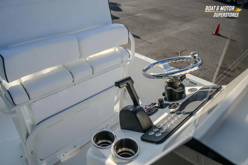 Slide: The Image of 2026 Skeeter SX230 boat interior with steering wheel and control panel. - 25