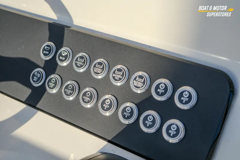 Slide: The Image of Control panel of 2026 Skeeter SX230 boat with labeled buttons for various functions. - 26