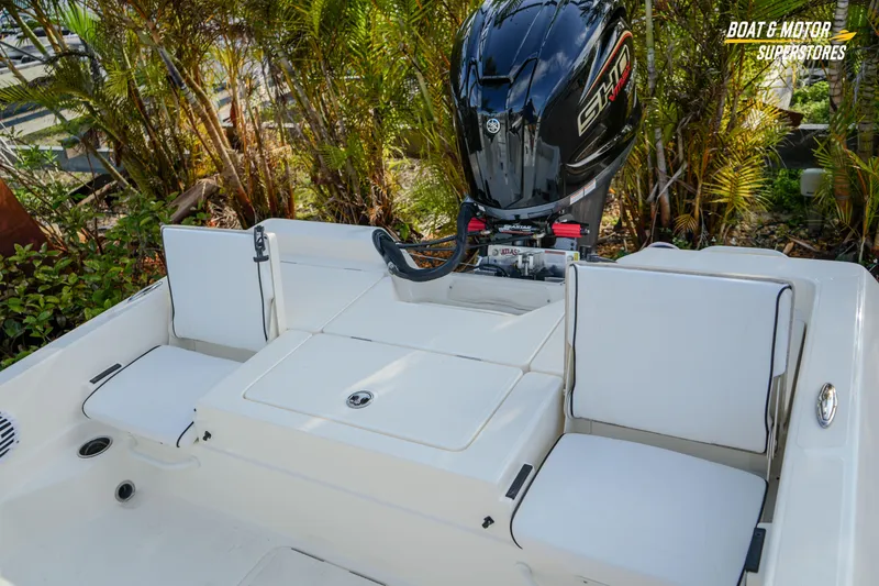 Slide: The Image of 2026 Skeeter SX230 boat with Yamaha engine, featuring white seating and lush greenery backdrop. - 27