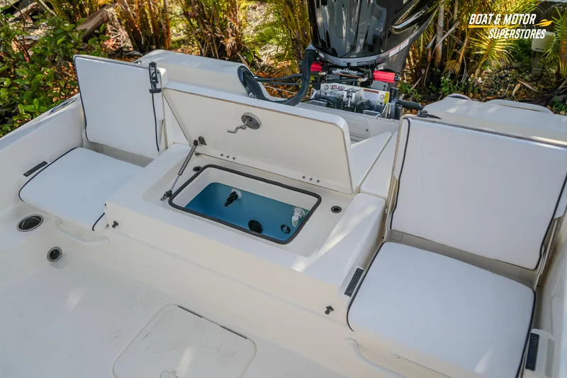Slide: The Image of 2026 Skeeter SX230 boat interior with open storage compartment and seating. - 28