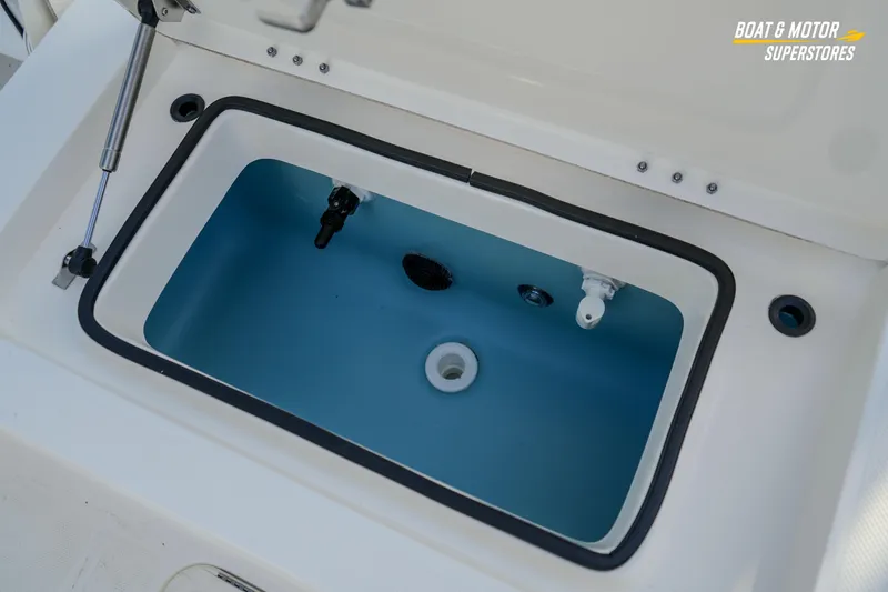 Slide: The Image of Livewell compartment in 2026 Skeeter SX230 boat, featuring a blue interior and secure lid. - 29