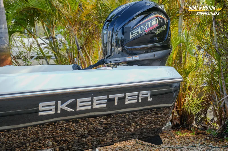 Slide: The Image of 2026 Skeeter SX230 boat with Yamaha SHO VMAX engine, surrounded by tropical plants. - 3