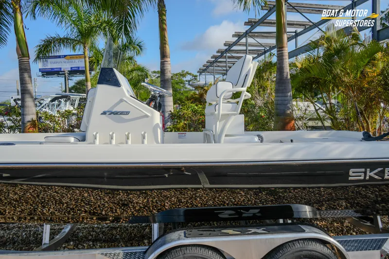 Slide: The Image of 2026 Skeeter SX230 boat displayed outdoors with palm trees in the background. - 4