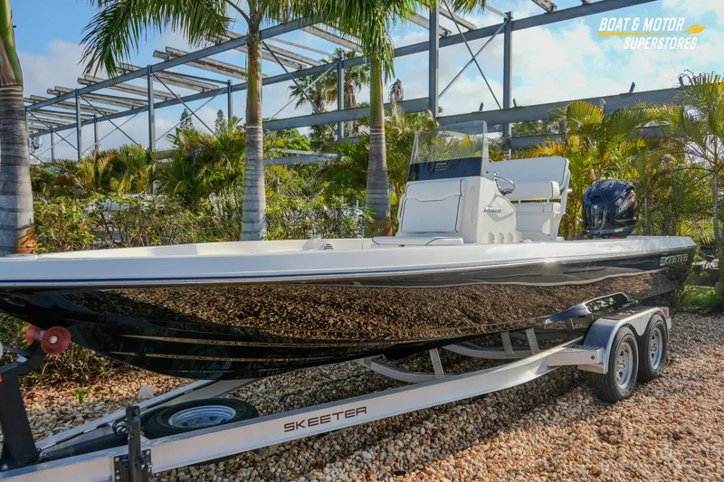 Slide: The Image of 2026 Skeeter SX230 boat on trailer, surrounded by palm trees and greenery. - 5