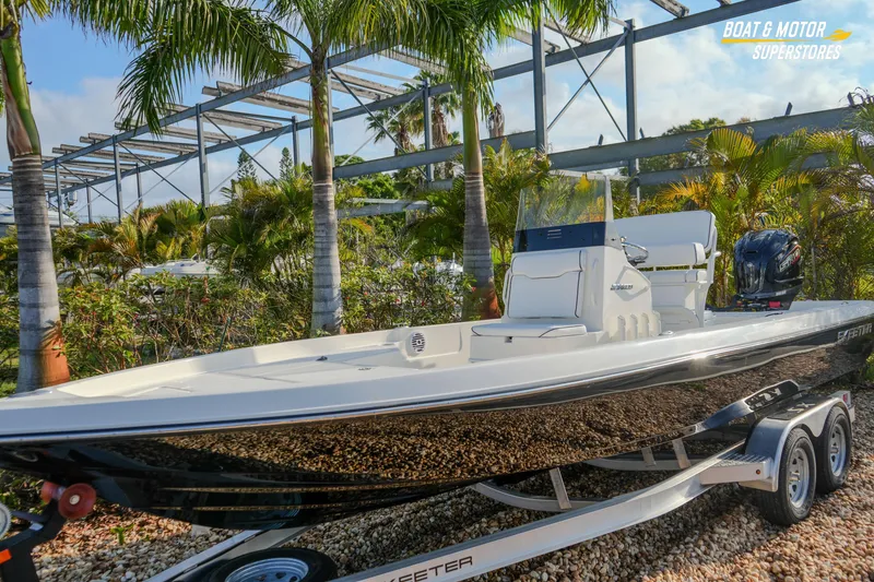 Slide: The Image of 2026 Skeeter SX230 boat on trailer, surrounded by palm trees at a dealership. - 6