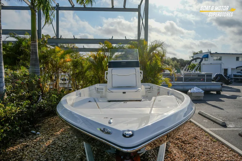 Slide: The Image of 2026 Skeeter SX230 boat displayed outdoors at a dealership, surrounded by palm trees. - 7