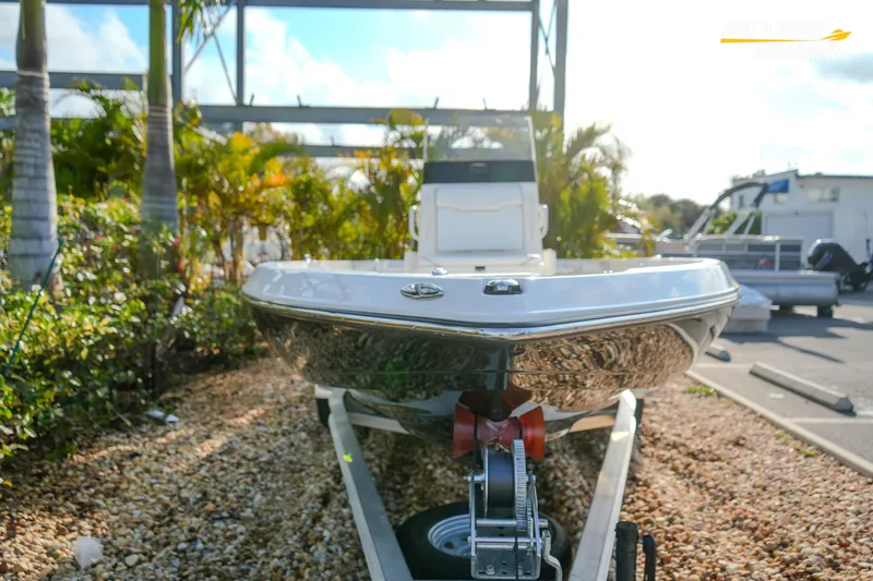 Slide: The Image of 2026 Skeeter SX230 boat on trailer, surrounded by tropical plants. - 8