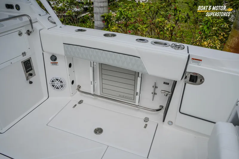 Slide: The Image of 2026 Blackfin 272 DC boat interior with storage compartments and sleek design. - 21