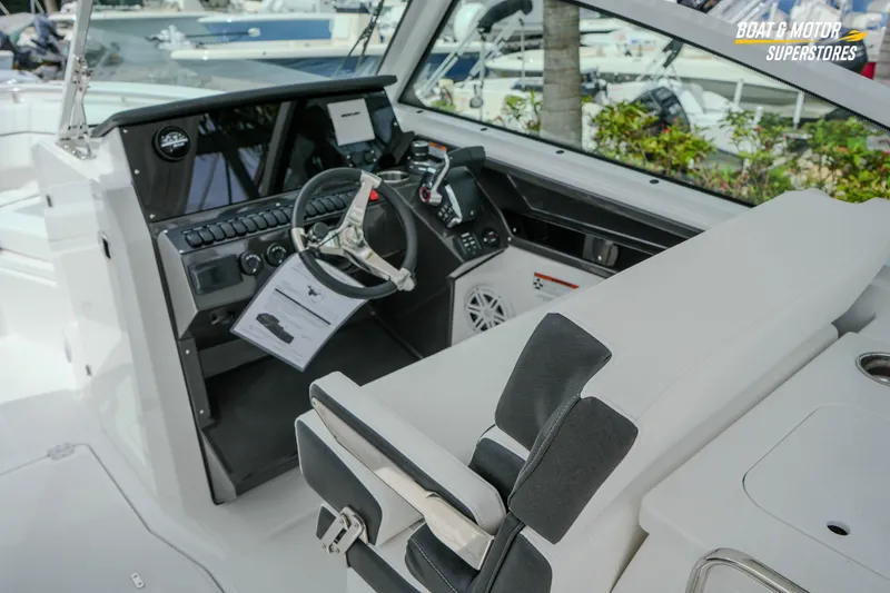 Slide: The Image of 2026 Blackfin 272 DC boat cockpit with modern steering and controls. - 26