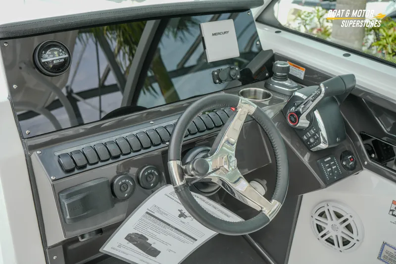 Slide: The Image of 2026 Blackfin 272 DC boat dashboard with steering wheel and control panel. - 27