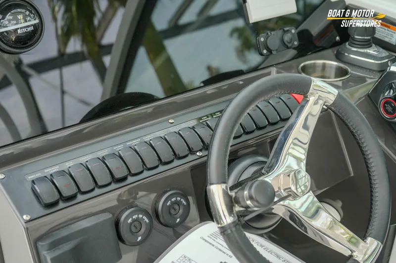 Slide: The Image of 2026 Blackfin 272 DC boat dashboard with steering wheel and control panel. - 28
