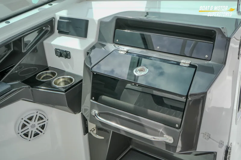 Slide: The Image of 2026 Blackfin 272 DC boat interior with cup holders and storage compartments. - 30