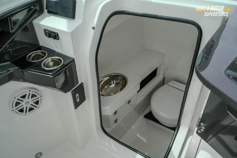 Slide: The Image of 2026 Blackfin 272 DC boat interior with toilet and cup holders. - 33