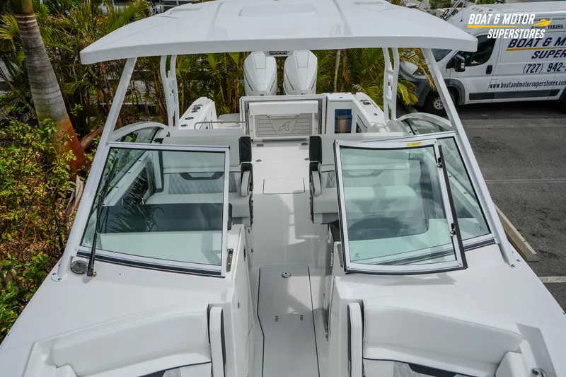 Slide: The Image of 2026 Blackfin 272 DC boat with open cockpit and dual consoles, parked outdoors. - 37