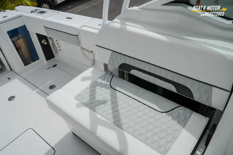 Slide: The Image of 2026 Blackfin 272 DC boat interior with white seating and storage compartments. - 44