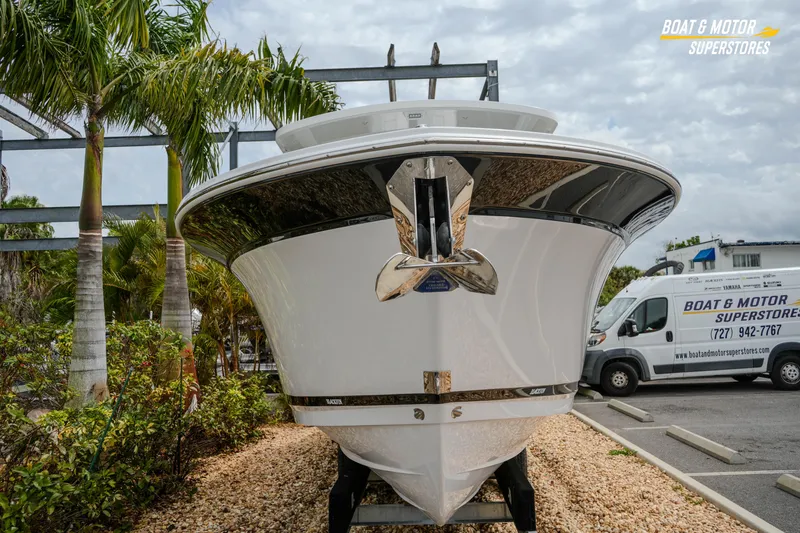 Slide: The Image of 2026 Blackfin 272 DC boat displayed at dealership with palm trees and van in background. - 5