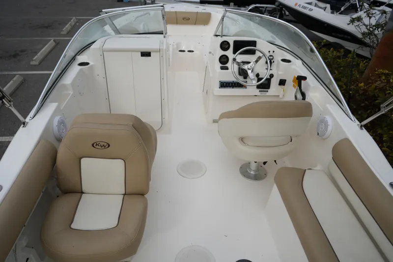 Slide: The Image of 2020 Key West 203 DFS boat interior with beige seating and steering console. - 17