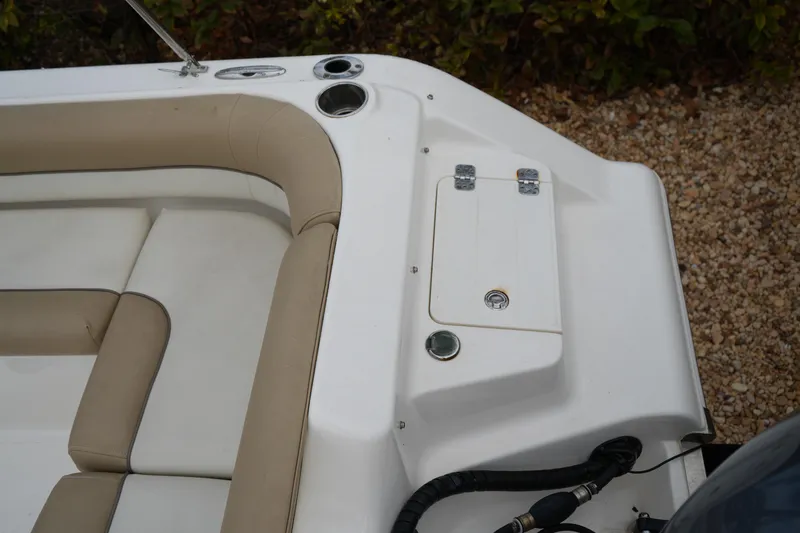 Slide: The Image of 2020 Key West 203 DFS boat interior with beige seating and storage compartment. - 19