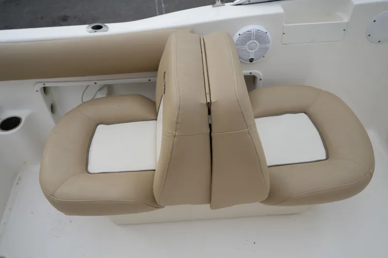 Slide: The Image of Beige and white seating on 2020 Key West 203 DFS boat, featuring cup holders and speaker. - 20